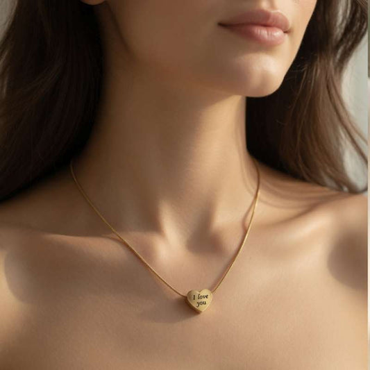 Gold necklace with a heart-shaped pendant on a model