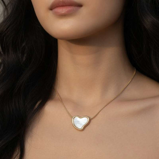 Heart-shaped pendant necklace on a model with dark hair