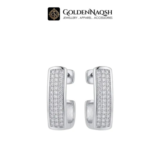 A pair of silver-toned huggie hoop earrings paved with small clear stones, shown on a plain white background with the GoldenNaqsh brand logo at the top.