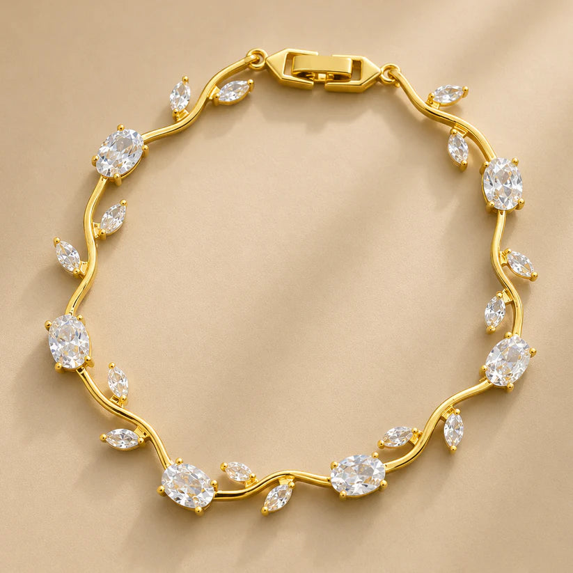 Gold bracelet with diamond-like stones on a beige background