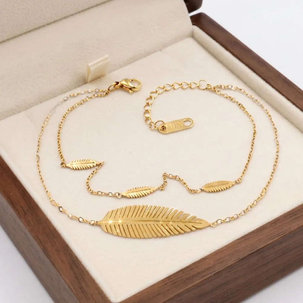 Angled display of the Golden Naqsh 4 leaf chain bracelet in a soft beige setting