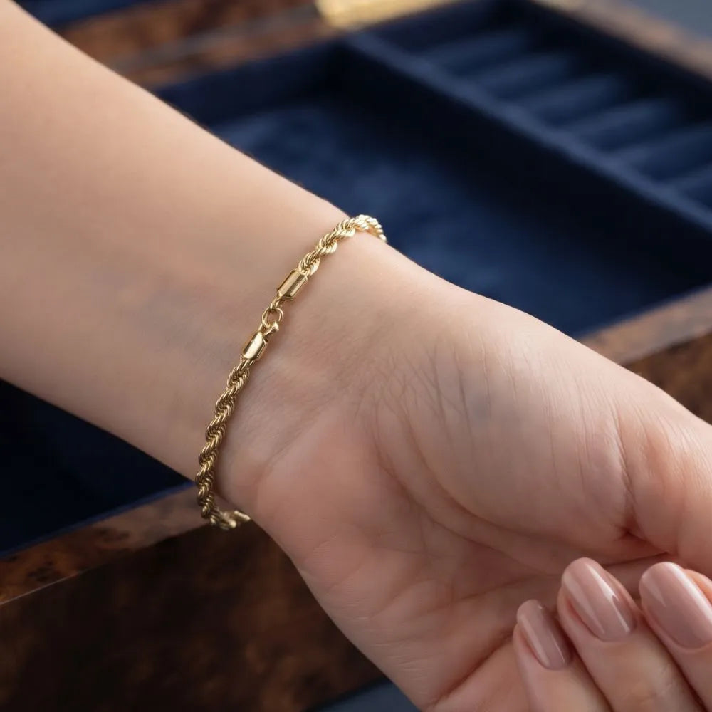 Close-up shot of a woman wearing the Golden Naqsh 18K gold plated twisted rope chain bracelet on her wrist for an elegant look
