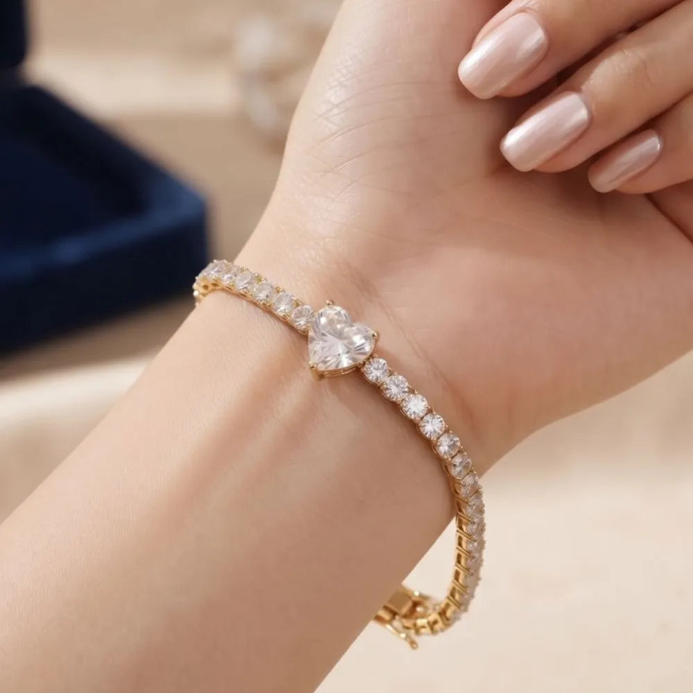 Close-up shot of a woman wearing the Golden Naqsh heart solitaire diamond tennis bracelet on her wrist