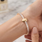 Close-up shot of a woman wearing the Golden Naqsh viral trending Oval Diamond Bracelet on her wrist, showcasing its luxurious everyday elegance