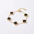 A gold chain bracelet featuring five alternating black clover-shaped links with gold borders, displayed on a clean white background.