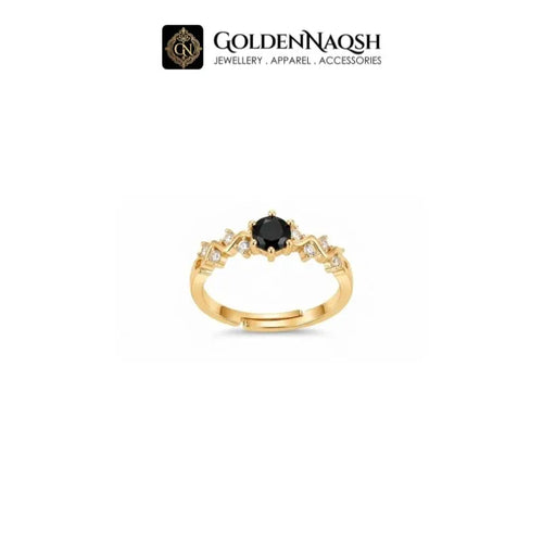 A gold ring with a central round black gemstone and small clear accent stones on a white background, with the GoldenNaqsh brand logo at the top.