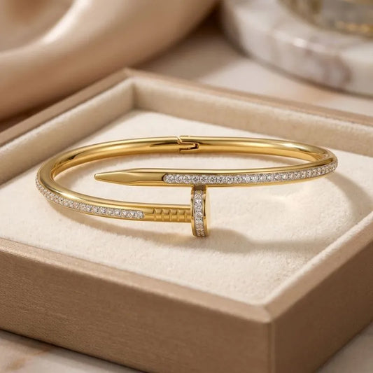 Gold bracelet with diamonds on a beige jewelry box