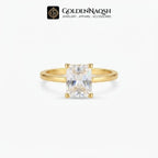 A gold ring with a rectangular clear gemstone in a four-prong setting, shown against a light gray background with the GoldenNaqsh brand logo at the top.
