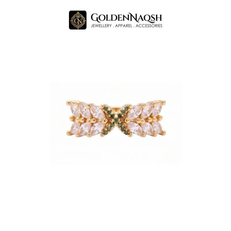 A gold butterfly ring with clear marquise-cut crystals and small green accent stones, shown on a white background with the GoldenNaqsh brand logo at the top.