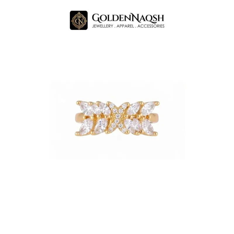A close-up of a person's hands with manicured nails, wearing a gold ring with rectangular clear stones on one finger. The GoldenNaqsh brand logo is visible at the top of the image.