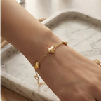 Golden Naqsh 3 Heart Chain Bracelet in 18K yellow gold featuring three smooth solid heart charms spaced along a delicate link chain