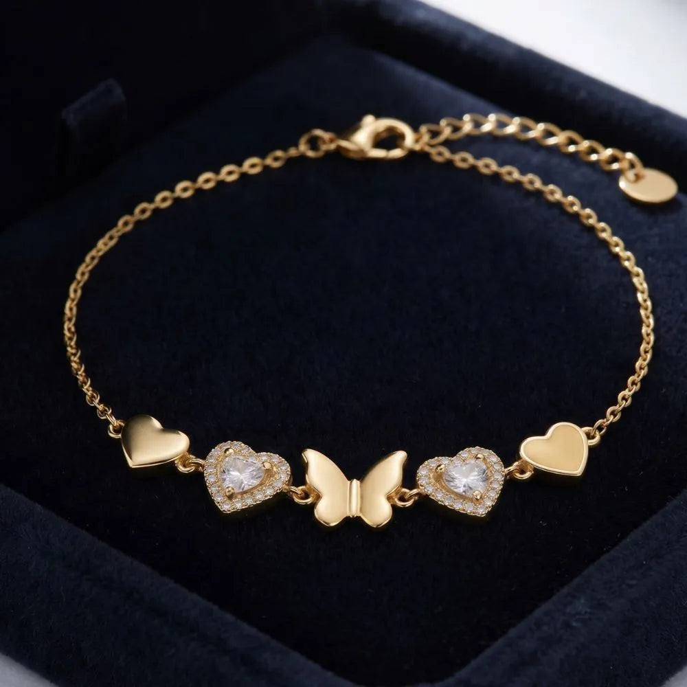 Golden Naqsh Butterfly & Heart Bracelet featuring a gold butterfly centerpiece flanked by crystal pave hearts and solid gold heart charms