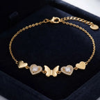 Golden Naqsh Butterfly & Heart Bracelet featuring a gold butterfly centerpiece flanked by crystal pave hearts and solid gold heart charms