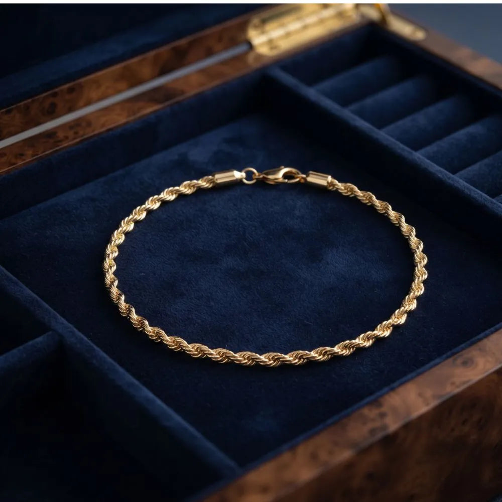 Golden Naqsh Twisted Rope Chain Bracelet in 18K gold plating displayed in a luxury dark blue lined jewelry box