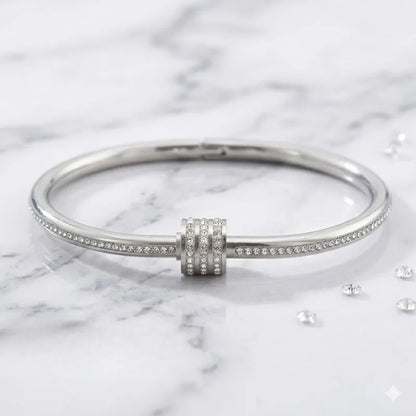 Silver bracelet with a clasp on a marble background