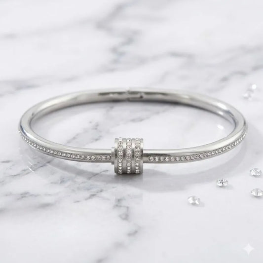 Silver bracelet with a clasp on a marble background