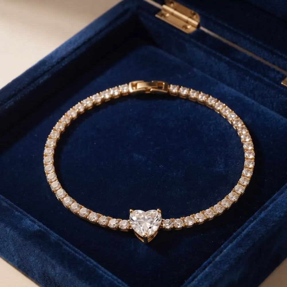 Top-down view of the Golden Naqsh 18K gold plated heart solitaire tennis bracelet displayed on dark blue lining